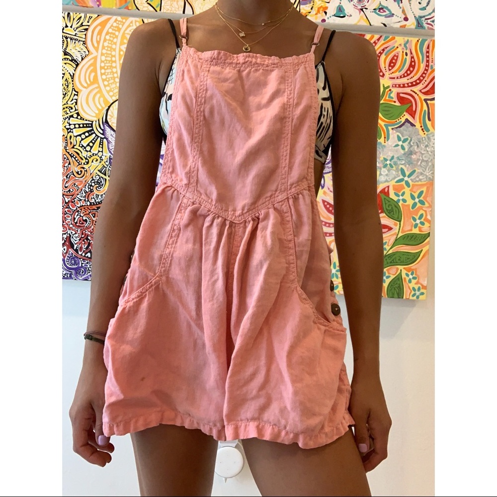 Hot pink flowy overalls.